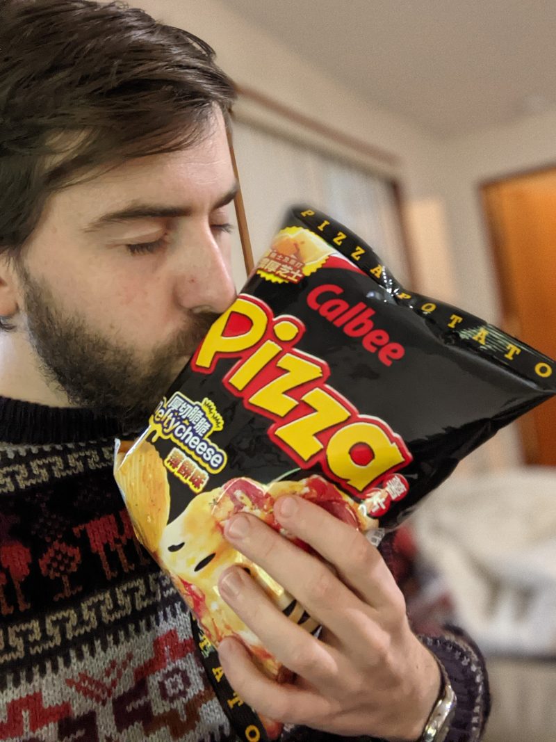 Alex smelling a bag of Calbee Pizza Potato chips